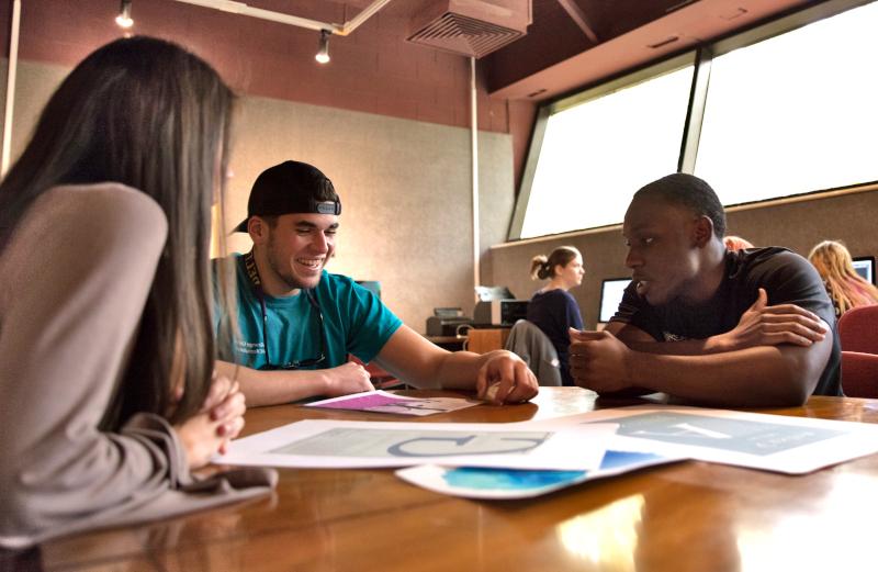 Three students in a classroom setting